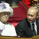 Russian President Vladimir Putin is accompanied by Her Majesty The Queen during a procession at The Mallat during the start iof his state visit on June 24, 2003 in London, England. Photo via Getty Images.